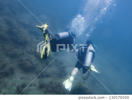 A man and a woman diving underwater on a coral reef in the South China Sea in Vietnam A man and a woman diving underwater on a coral reef in the South China Sea in Vietnam 130570509