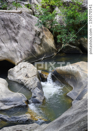 Huge rocks in a mountain river in a tropical forest in Vietnam Huge rocks in a mountain river in a tropical forest in Vietnam 130570541