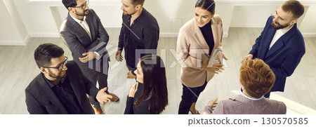 View from above of smiling business colleagues communicating in office 130570585