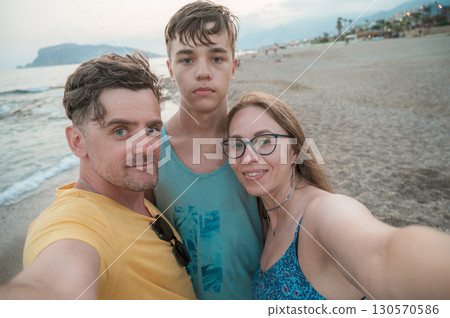 Happy family taking a photo Happy family taking a photo 130570586