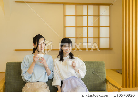 Two women drinking tea 130570920