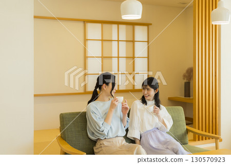 Two women drinking tea 130570923