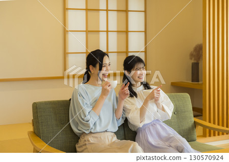 Two women drinking tea 130570924