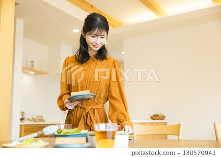A woman serving a meal 130570941