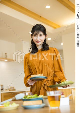 A woman serving a meal 130570944