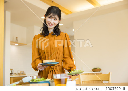 A woman serving a meal 130570946