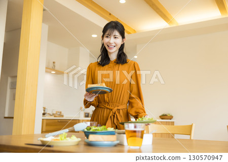 A woman serving a meal 130570947