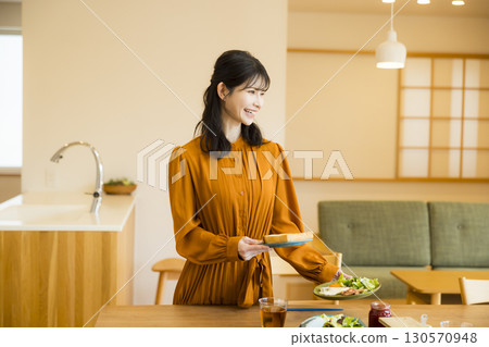 A woman serving a meal 130570948