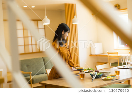 A woman serving a meal 130570950