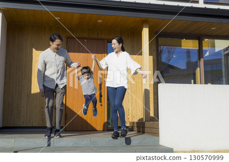 A family standing in front of a family 130570999