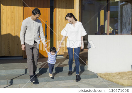 A family standing in front of a family 130571008