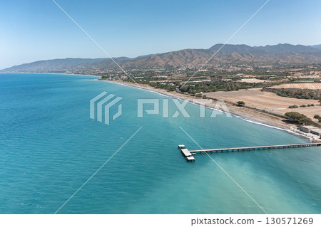 Aerial view of Polis coastline featuring a long pier stretching into the Mediterranean Sea, Cyprus Aerial view of Polis coastline featuring a long pier stretching into the Mediterranean Sea, Cyprus 130571269