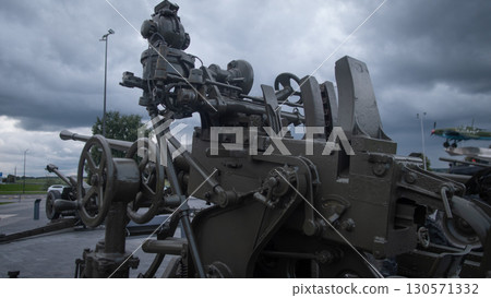 A powerful cannon positioned against a stormy sky illustrates the serious reality of war in Russia, revealing the tension and historical significance of military machinery. 130571332