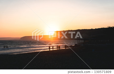 Tourists enjoying sunset at Kourion beach in Cyprus 130571809