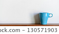 Blue coffee mug on wood table and white background with copy space. Selective focus on Coffee cup. 130571903