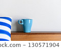 Blue coffee mug on wood table and white background with copy space. Selective focus on Coffee cup. 130571904