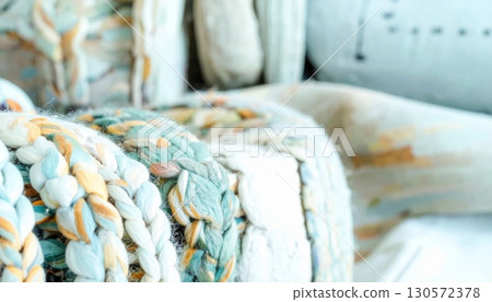 Close Up of Abstract Braided Chair with Blue and Yellow Patterned Upholstery Close Up of Abstract Braided Chair with Blue and Yellow Patterned Upholstery 130572378