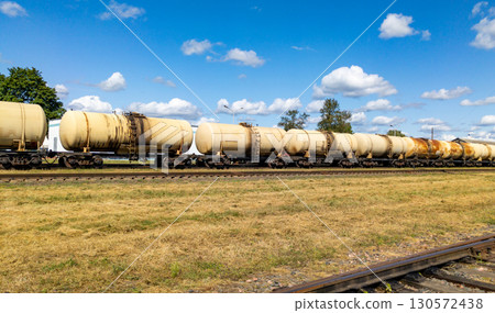 Railway tank cars used to transport petroleum products. Identification markings have been removed. The fuel train with petrochemical tank cars. 130572438