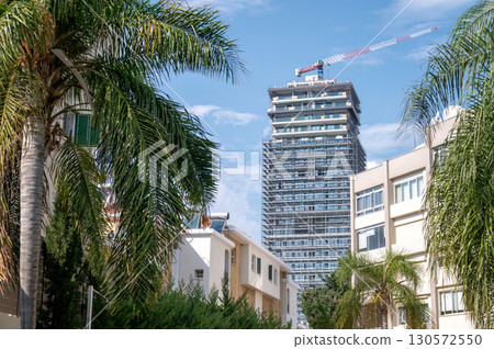 Construction site of modern skyscraper rising above Limassol cityscape in Cyprus 130572550