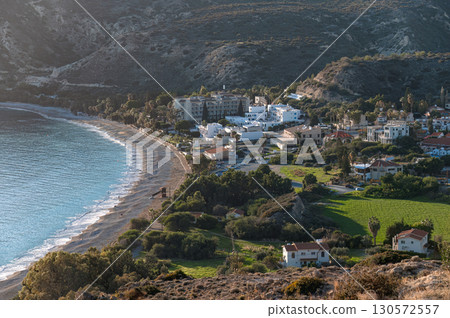 Pissouri village, with its hotels and houses, basks in the golden light of sunset, overlooking the beautiful mediterranean sea in Cyprus Pissouri village, with its hotels and houses, basks in the golden light of sunset, overlooking the beautiful mediterranean sea in Cyprus 130572557