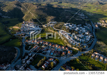 Pissouri village perched among verdant hills, revealing stunning landscape panorama of rural Cyprus with dramatic aerial perspective Pissouri village perched among verdant hills, revealing stunning landscape panorama of rural Cyprus with dramatic aerial perspective 130572564