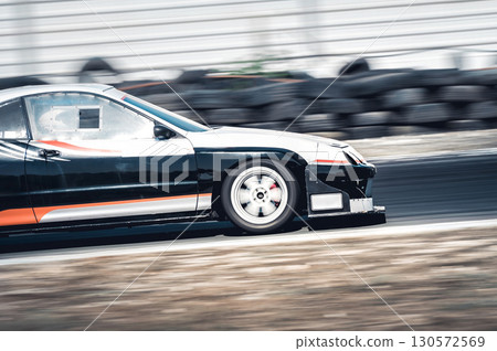 Tuned sports car racing on a circuit, showcasing high-speed action during an exhilarating time attack motorsport competition 130572569