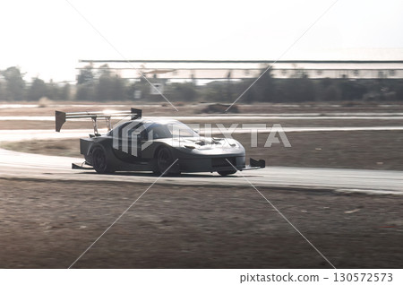 Gray-tuned sports car drifting on a racetrack during an intense time attack competition, showcasing speed and precision in every turn Gray-tuned sports car drifting on a racetrack during an intense time attack competition, showcasing speed and precision in every turn 130572573