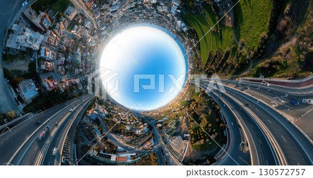 Limassol cityscape bending into spherical panorama, revealing urban landscape and highway network against vibrant blue sky from aerial perspective 130572757
