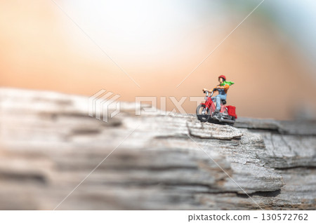 Miniature figurine of man travelling on motorcycle 130572762