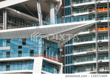 Modern skyscraper under construction with glass facade and unique architectural design in Limassol, Cyprus Modern skyscraper under construction with glass facade and unique architectural design in Limassol, Cyprus 130572804