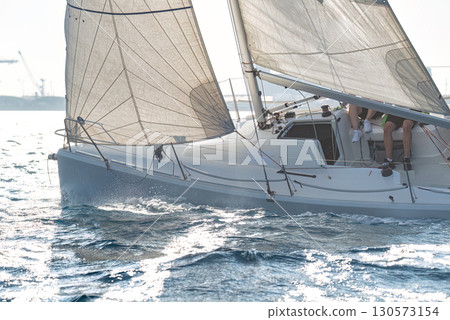Competitive sailing at regatta in mediterranean sea 130573154