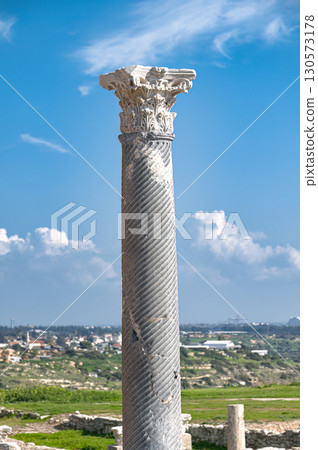 Fluted column with corinthian capital in the Kourion archaeological site, overlooking the landscape of episkopi, Cyprus Fluted column with corinthian capital in the Kourion archaeological site, overlooking the landscape of episkopi, Cyprus 130573178
