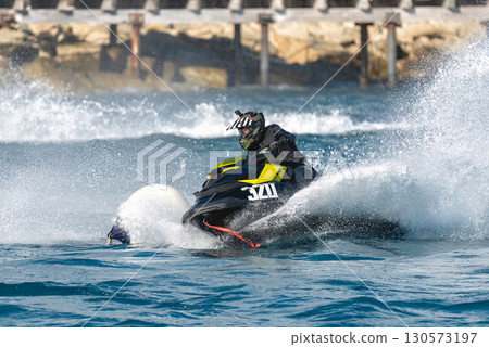 Professional athlete riding a water scooter in a race on the sea 130573197