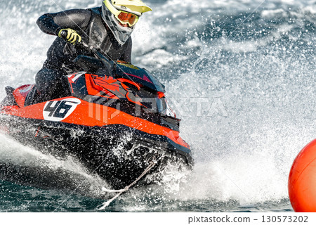 Jetski pilot is competing at high speed Jetski pilot is competing at high speed 130573202