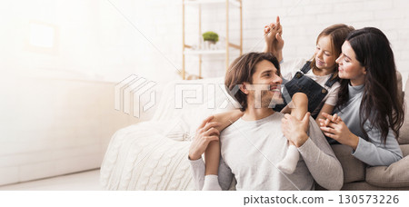 Happy family at home playing together in living room Happy family at home playing together in living room 130573226