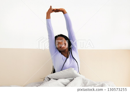 Good Morning. Rested African American Girl Stretching Raised Arms Waking Up Sitting In Comfortable Bed In Cozy Bedroom. Empty Space Good Morning. Rested African American Girl Stretching Raised Arms Waking Up Sitting In Comfortable Bed In Cozy Bedroom. Empty Space 130573255