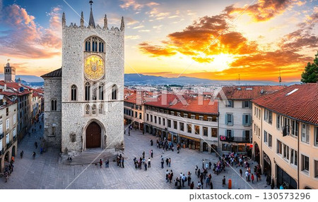 Romanesque Clock Tower Dominates Lively Square at Sunset, Embrun 130573296