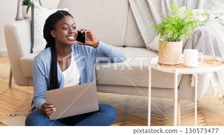 Freelance Career. Guy Talking On Cellphone Using Laptop Sitting On Floor At Home. Free Space For Text Freelance Career. Guy Talking On Cellphone Using Laptop Sitting On Floor At Home. Free Space For Text 130573477