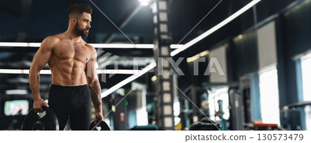 Young muscular athlete exercising with barbell weights in gym interior, empty space, panorama Young muscular athlete exercising with barbell weights in gym interior, empty space, panorama 130573479