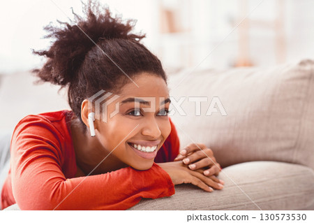 Enjoy Weekend. Smiling African American Girl In Earbuds Listening To Music Relaxing At Home. Selective Focus 130573530