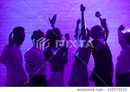Group Of Cheerful Young People Dancing Having Fun At Corporate Night Party Indoor. Low Light 130573532
