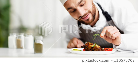 Cook Man Decorating Chicken Dish Preparing Dinner In Restaurant Kitchen Indoor. Cropped, Selective Focus 130573702