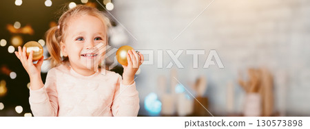 Little kid with Christmas balls enjoying winter holidays at home Little kid with Christmas balls enjoying winter holidays at home 130573898