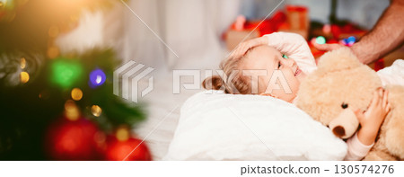Christmas Eve. Adorable little little girl going to sleep on Xmas night, free space 130574276