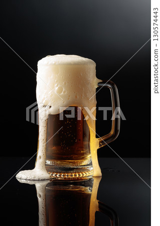 Mug of beer on a black background. Mug of beer on a black background. 130574443