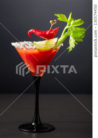 Bloody Mary cocktail with celery, lime, and red pepper. Bloody Mary cocktail with celery, lime, and red pepper. 130574450