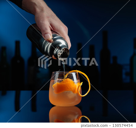 Cocktail Auld Draper on a black table in a bar. 130574454
