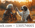Senior woman and dog looking at sunset in open field, calm scene of companionship and natural beauty. 130574665