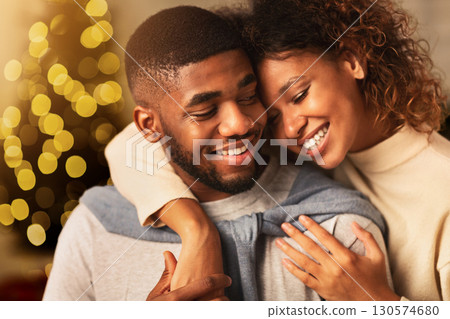 Couple in love spending christmas eve, hugging and enjoying evening at home 130574680