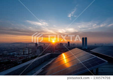 Sunset view from rooftop with solar panels overlooking cityscape and buildings 130574708